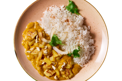 Kokoshuhn von Hofmanns Shop: Basmati-Reis, gelbe Curry-Kokossoße, Hähnchenbrust, Kokosstücke.