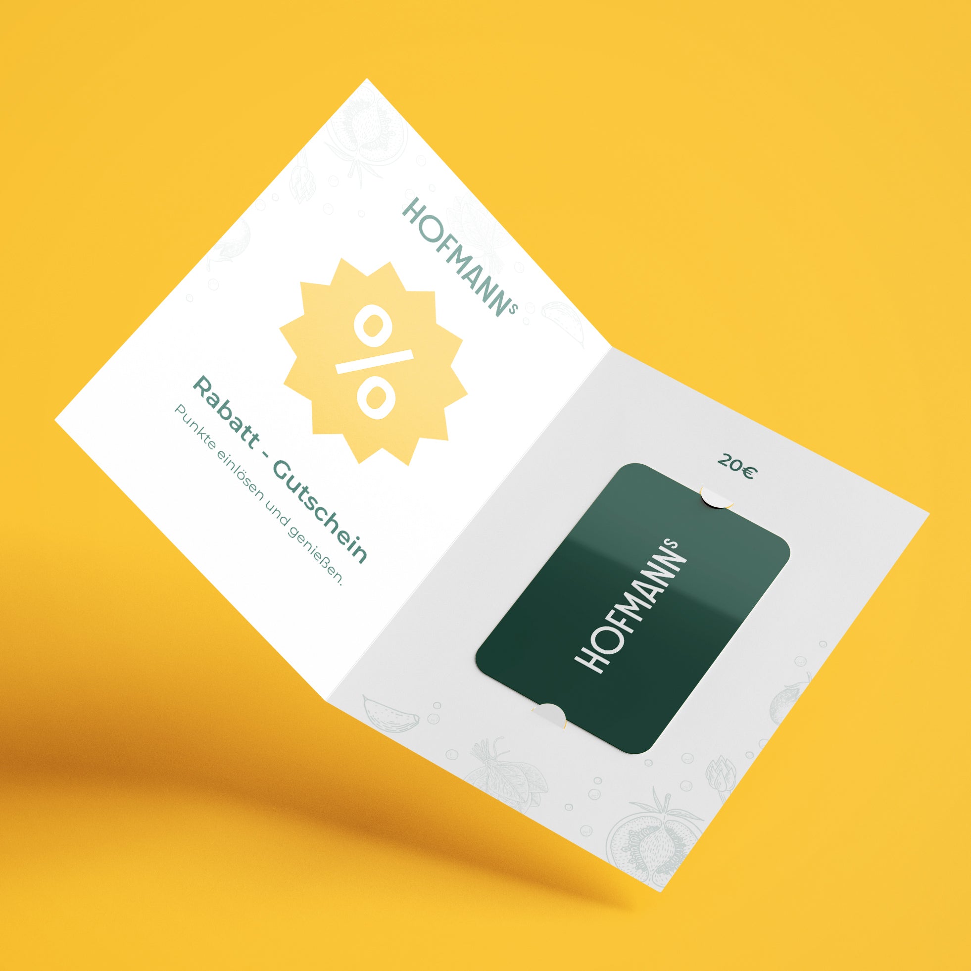 Geöffnete Hofmann-Gutscheinkarte auf gelbem Grund, im Inneren befindet sich eine grüne Geschenkkarte im Wert von 20 Euro.